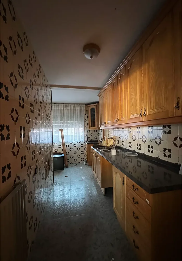 Cocina antigua antes de la reforma, con azulejos de dibujo y muebles de madera